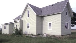 Home with siding and gray shingle roof